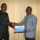 Mr Martin Adu-Owusu (right) handing over the document to Prof. Kwamena Kwansah -Aidoo
