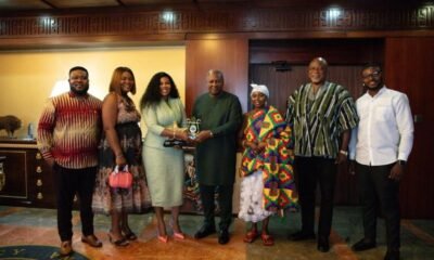 Empress Gifty together with her management in a group photograph with president Mahama