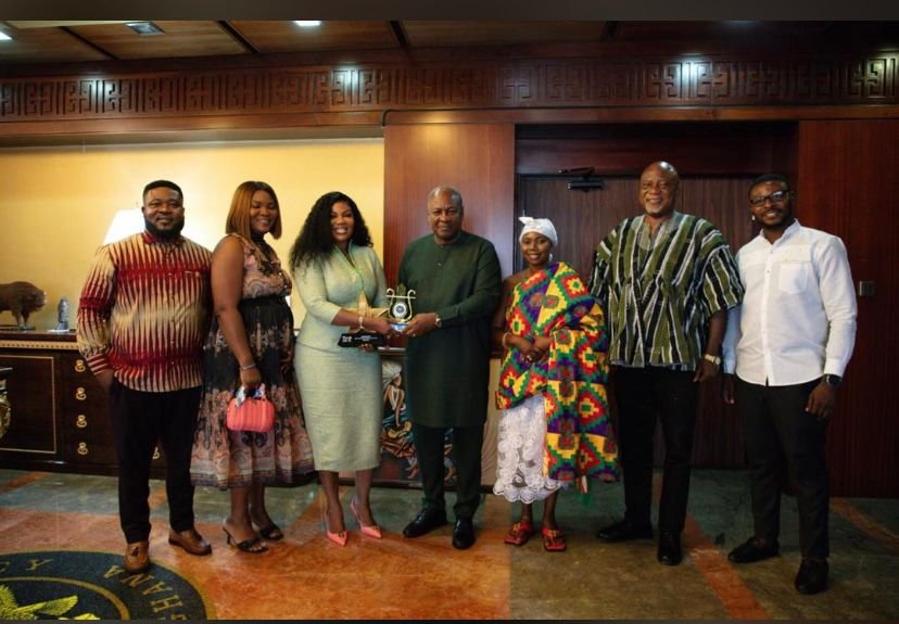 Empress Gifty together with her management in a group photograph with president Mahama