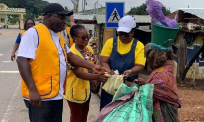Members of the club giving food to a mental patient