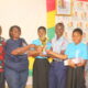 Mrs Gloria A. Kudo (left) Deputy Regional Director,NCCE, Greater Accra Region presenting the winner trophy to all Saints Anglican Model Basic school Photo: Ebo Gorman