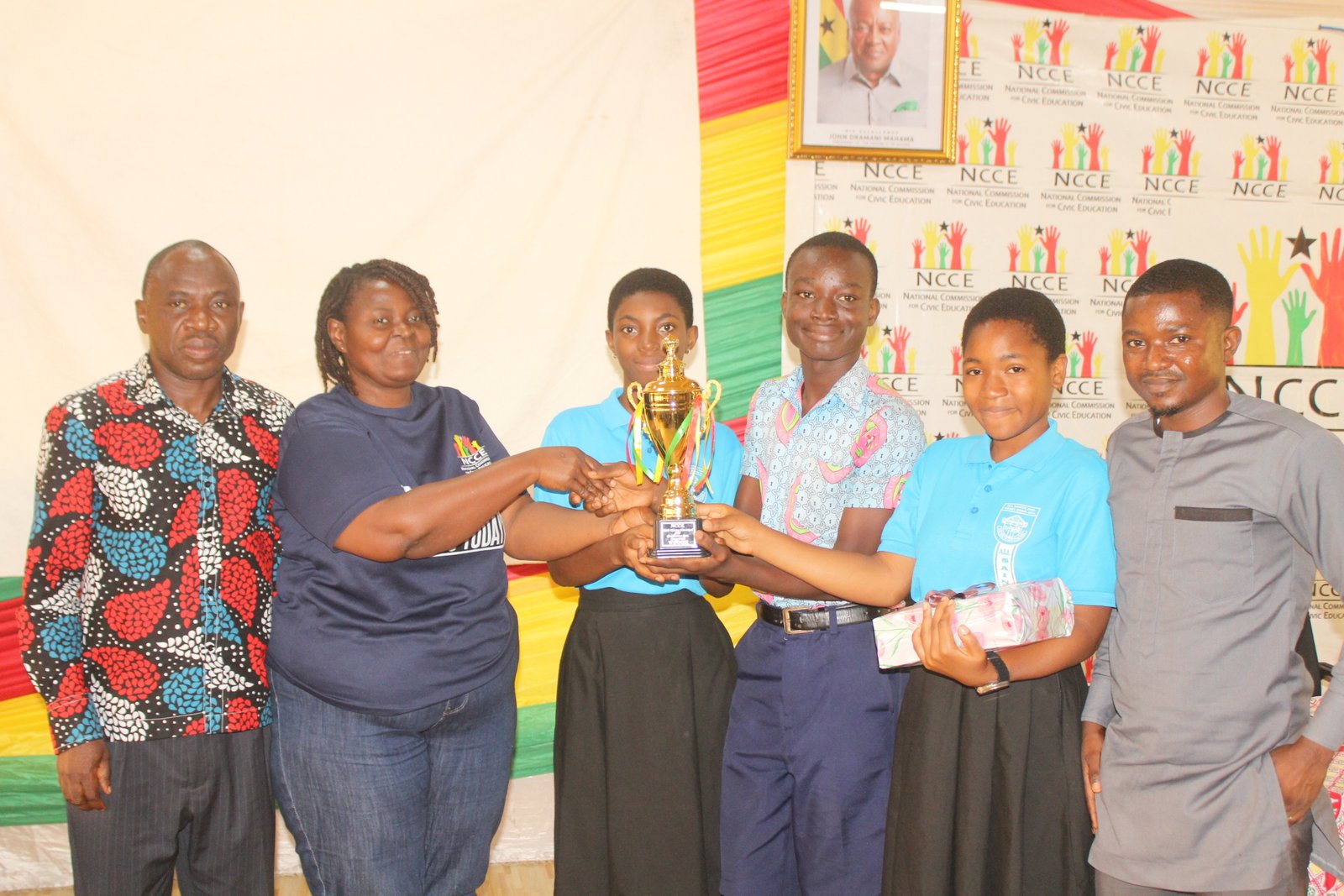 Mrs Gloria A. Kudo (left) Deputy Regional Director,NCCE, Greater Accra Region presenting the winner trophy to all Saints Anglican Model Basic school Photo: Ebo Gorman