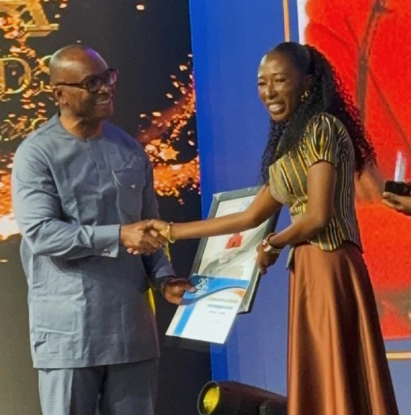 -Ms Abigail Annoh (right) of The Ghanaian Times receiving her award