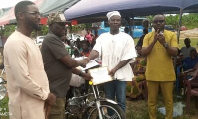 Mr Francis Dufe (Third from left) presenting a certificate to the best farmer