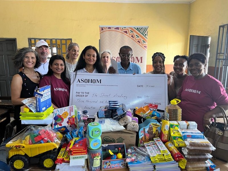 Mrs Malika Mene and Mrs Sovanna Taliercio and their members present the items to Ataa Lartey