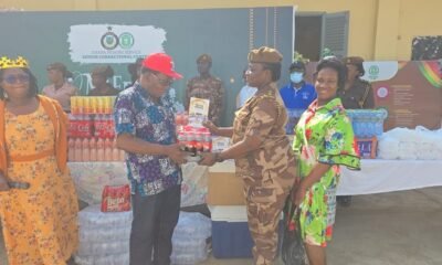 Rev Mensah (Left) presenting the items to DSP Joyce Adubea Tieku while others look on