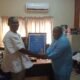 Mr Cephas Aveh (left) receiving a citation from Mr Koomson