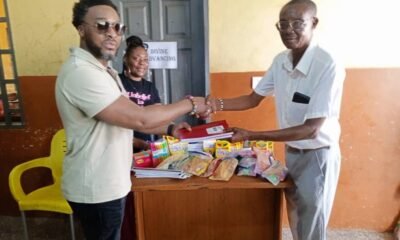 Ataa Lartey receiving some of the items donated to the academy