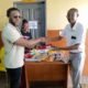 Ataa Lartey receiving some of the items donated to the academy
