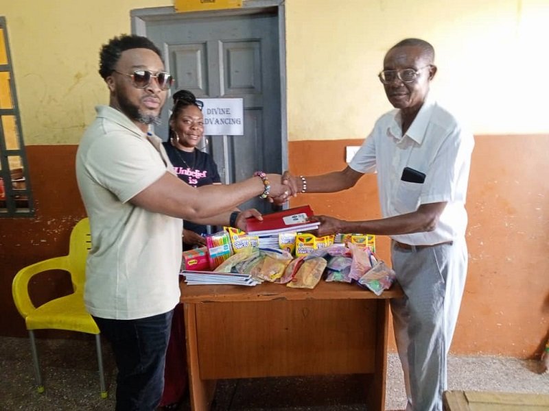 Ataa Lartey receiving some of the items donated to the academy
