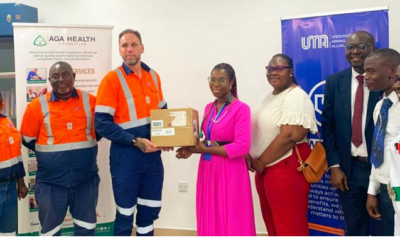 Mr Ehen (left) presenting the items to Dr Apawu (right) with others looking on