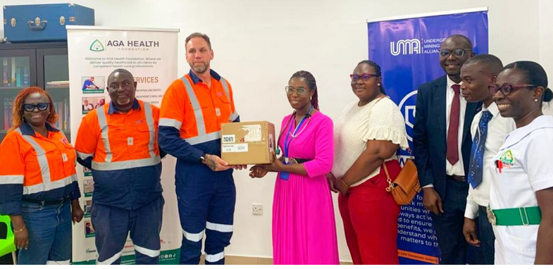 Mr Ehen (left) presenting the items to Dr Apawu (right) with others looking on