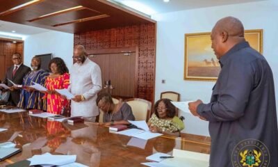 President Mahama (right) administers the Oath of Office to members of the Council