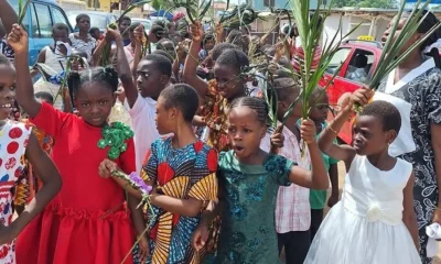 Children waving palm fronds