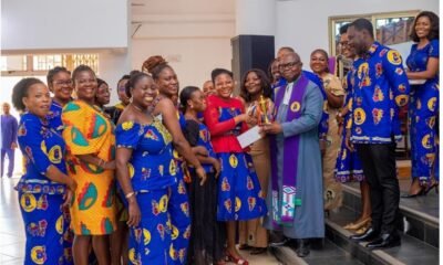 Very Rev Joseph Odei-Afrifa presenting a trophy to Mrs Lilian Anim Amissah and Team SUWMA