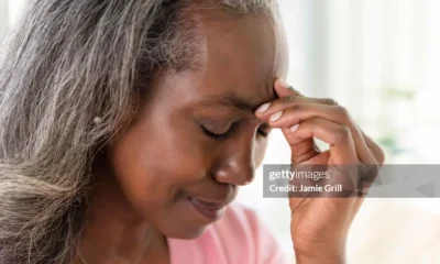 An elderly woman suffering from headache