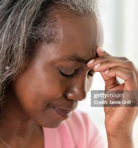 An elderly woman suffering from headache