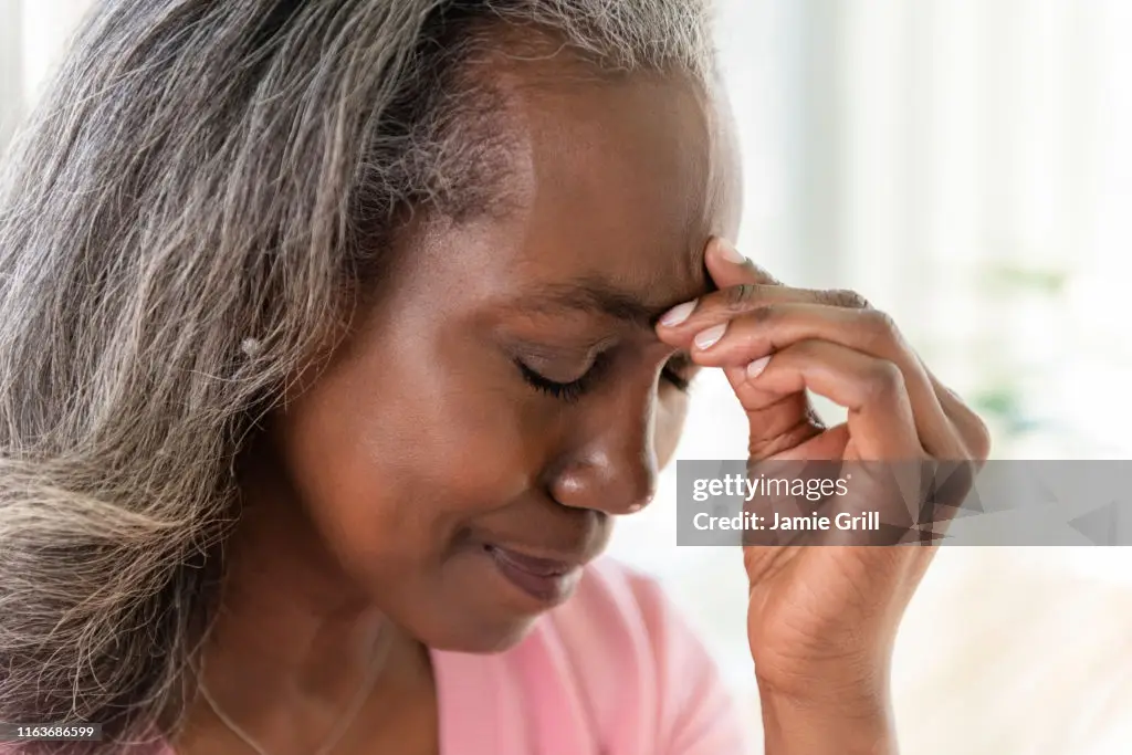 An elderly woman suffering from headache