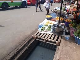 Food stuff being sold near an open gutter