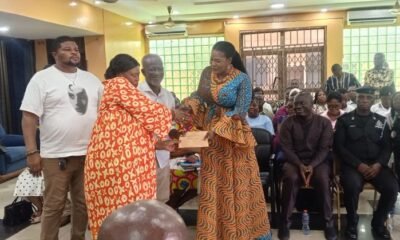 Ms Bright presenting the cash to a representative to TTC