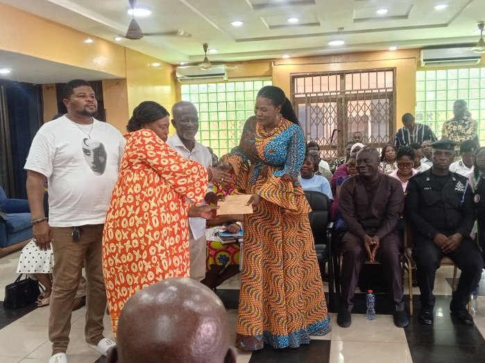 Ms Bright presenting the cash to a representative to TTC