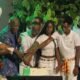 Okyeame Kwame flanked by his children and chairman of the occasion cut the birthday cake