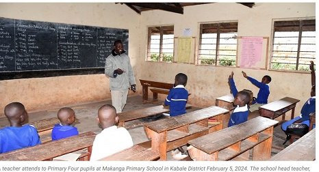 A teacher attending to pupils
