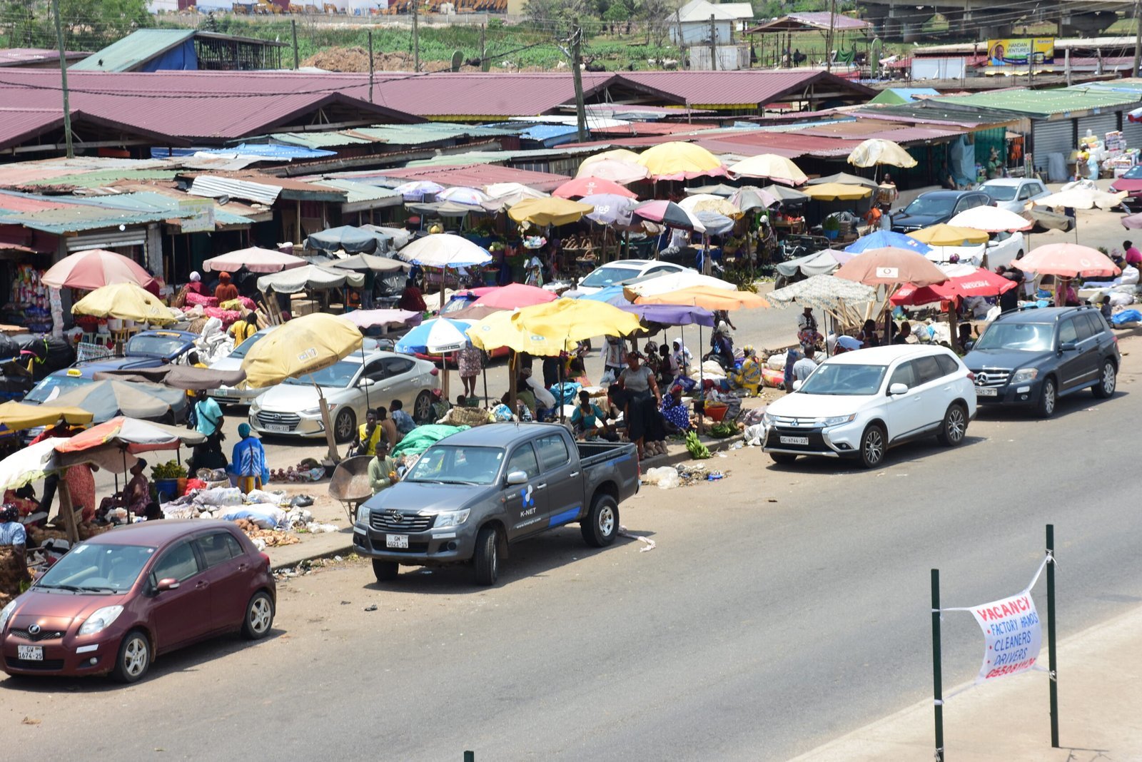 vehichles parked on the shoulders of the road