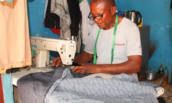 Chidi Peter Igwe Okenyi sewing a shirt