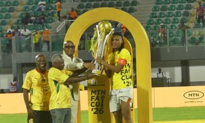 GFA Vice President, Mark Addo and FA Cup officials present the trophy to skipper Razak Simpson