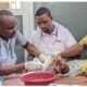 Health professionals attending to a child with clubfoot