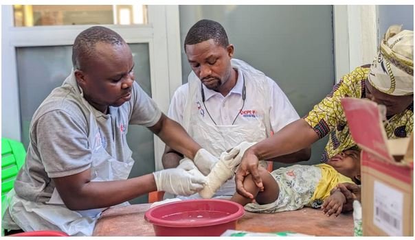 Health professionals attending to a child with clubfoot
