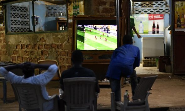 A man watching a digital television
