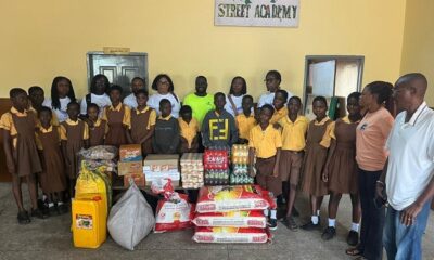 Children, management and members of the Foundation with the items