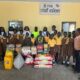 Children, management and members of the Foundation with the items