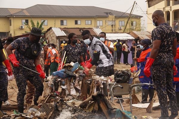 Police personnel collecting some of the rubbish