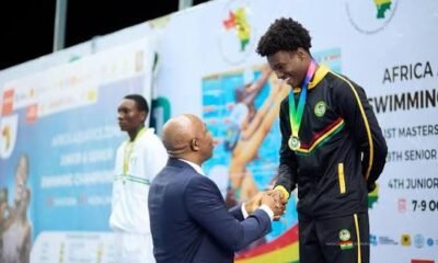 Snowden receives an award after winning 50m breaststroke