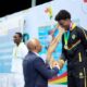 Snowden receives an award after winning 50m breaststroke