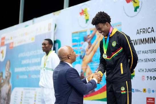 Snowden receives an award after winning 50m breaststroke