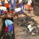 Some of the school children desilting choked gutters.