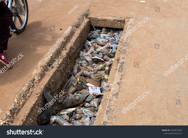 A gutter choked with plastic waste