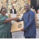 Mr Afenyo-Markin presenting a laptop to one of the beneficiaries