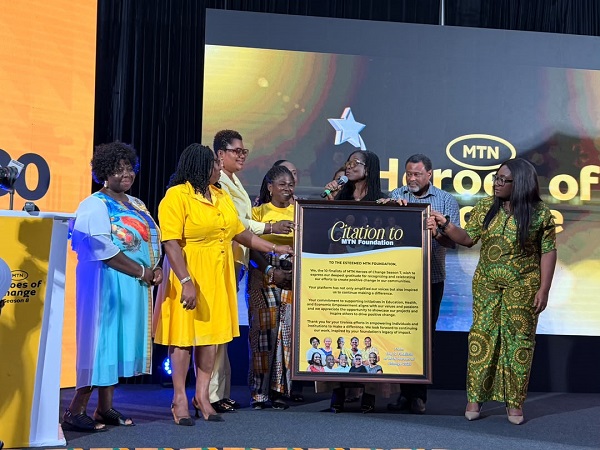 Season seven winner (in yellow) and finalist presenting citation to Georgina and other staff of MTN