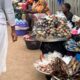 Some hawkers sitting behind their wares on the footbridge