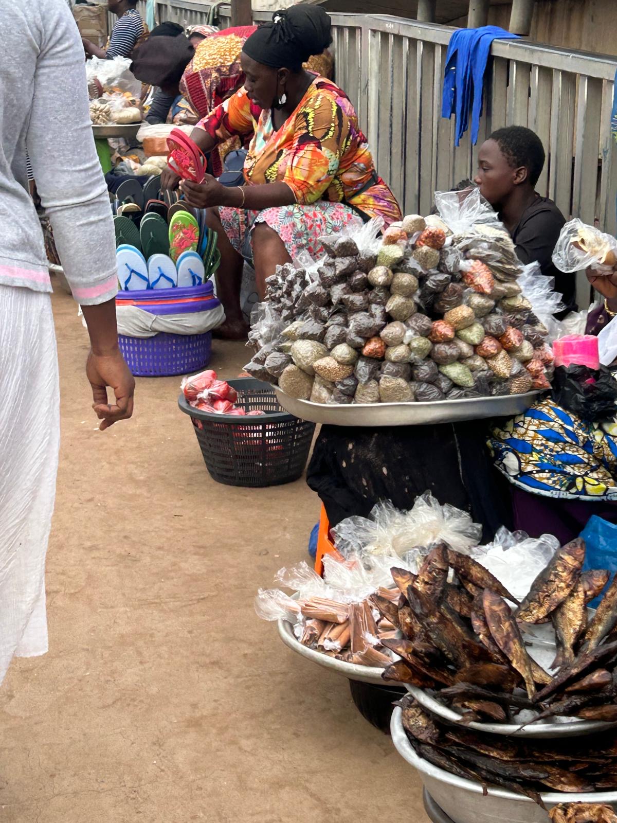 Some hawkers sitting behind their wares on the footbridge