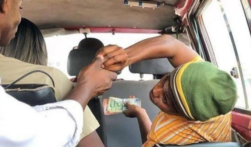 A passenger demands change from a driver's mate