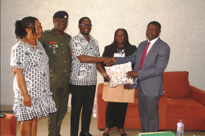 Mr Eshun (middle) presenting a gift to Dr Okpoti Nai (right) during the visit. With them are Mrs Quaittoo (second from right), Rev Canon Dr Lt Col Lokko (second from left) and Ms Tetteh Photo Lizzy Okai