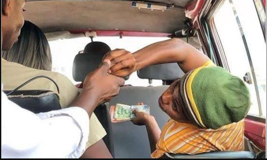 A passenger demands change from a driver's mate