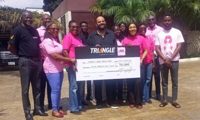 Ms Gozo (right) receiving the cheque from Mr Fouad (middle)