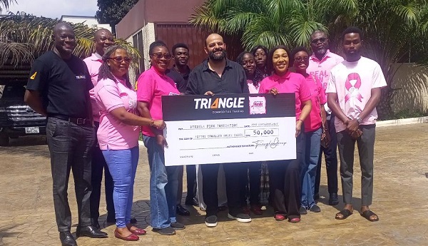 Ms Gozo (right) receiving the cheque from Mr Fouad (middle)